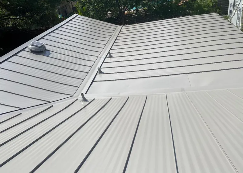 Solar attic fan installed on a metal roof for Roof Ventilation in Forestville
